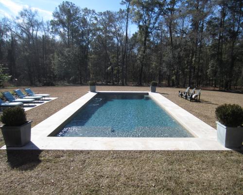 Adel saltwater pool featuring clear water and a beautifully designed deck.