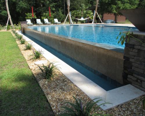 Monticello custom pool design with premium outdoor features and stone deck.