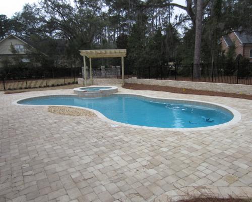 Quitman custom pool design showcasing blue water and stone deck.