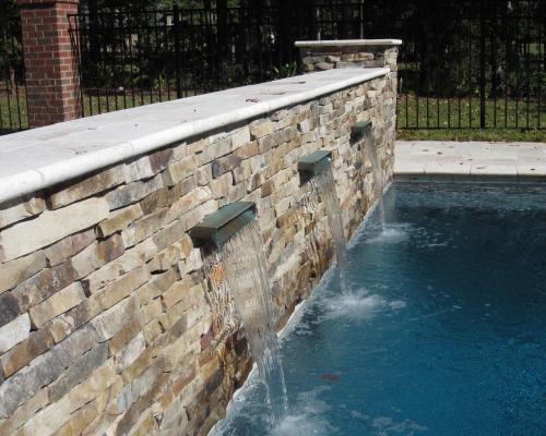 Saint George Island custom pool design with coastal features and stone deck.