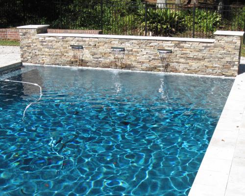 Thomasville custom pool design with luxury finishes and blue water.