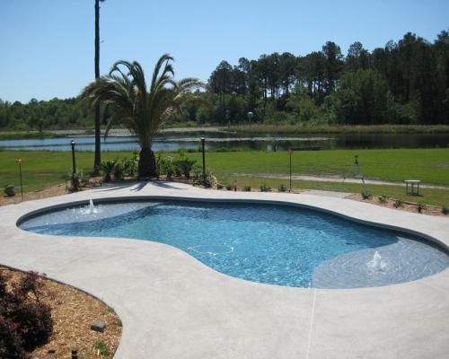Quitman saltwater pool with bright blue water and updated outdoor features.