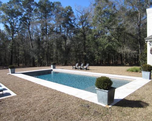Monticello swimming pool construction featuring custom gunite work and stone deck.