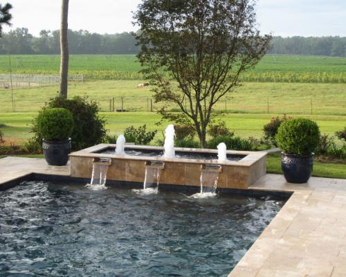 Valdosta swimming pool construction showcasing custom design and quality stone decking.